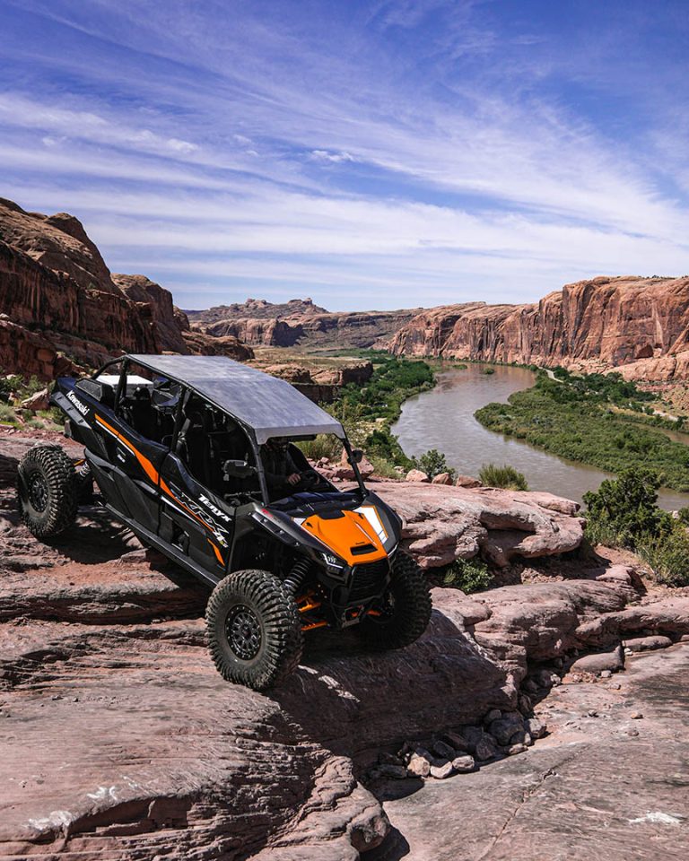 A rugged UTV parked on a rocky hillside, ready for an epic 4x4 adventure.