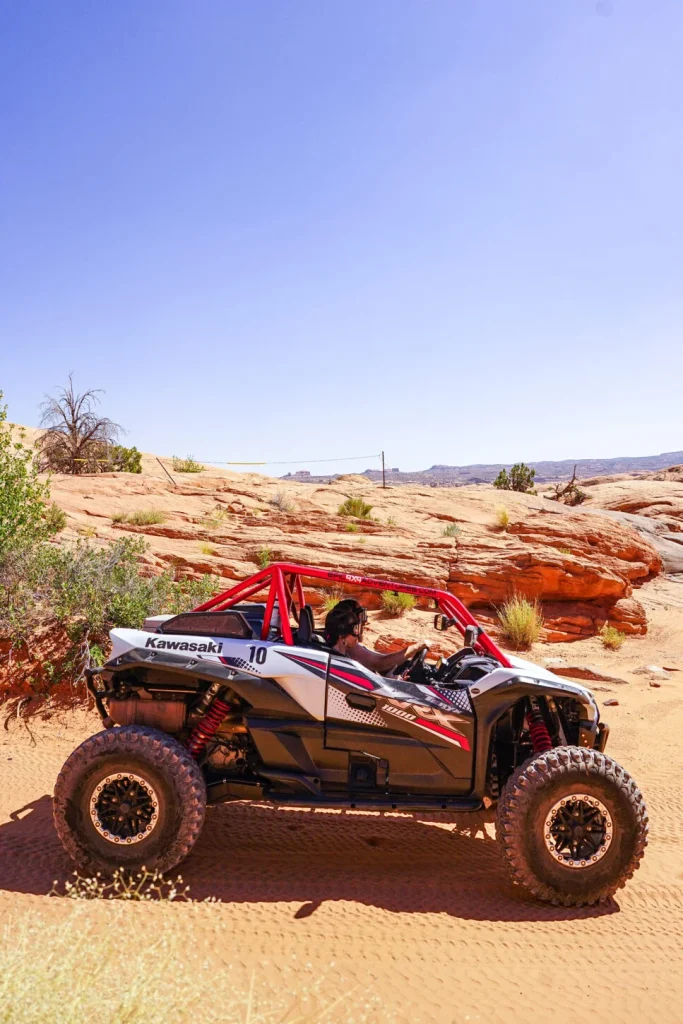 a person riding a four wheeler in the desert